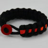black lgbtq support paracord bracelet with rainbow line and red button fastener in the front