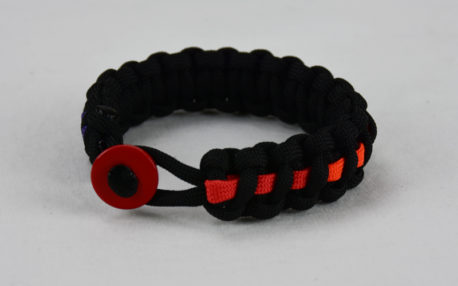 black lgbtq support paracord bracelet with rainbow line and red button fastener in the front