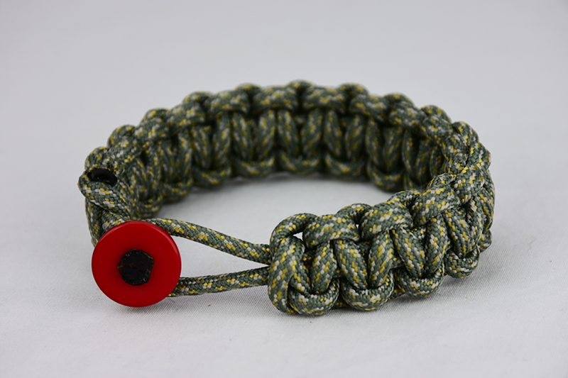 acu camouflage paracord bracelet unity band with red button in front, picture of an acu camouflage paracord bracelet unity band with red button fastener in the front of a white background