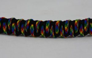 black with autism tiger stripe paracord bracelet across the center of a white background