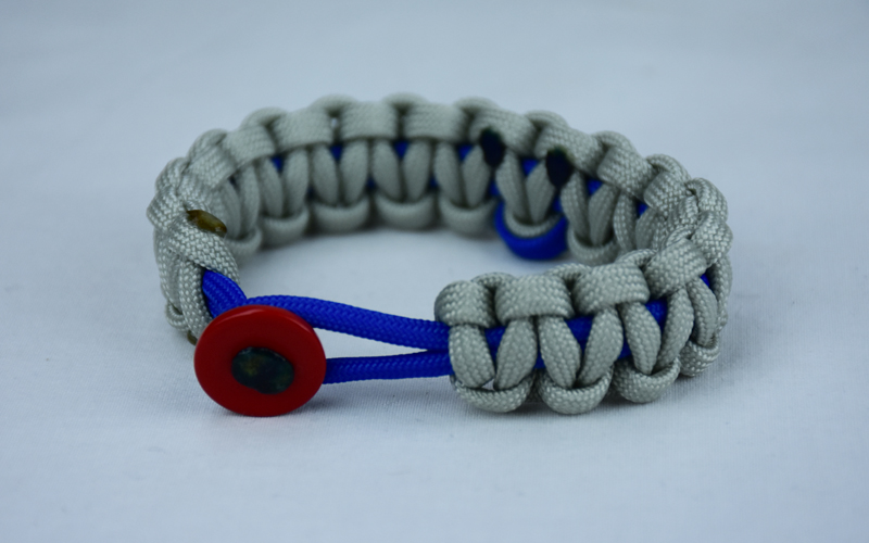 blue and grey anti bullying paracord bracelet with red button front and blue ribbon