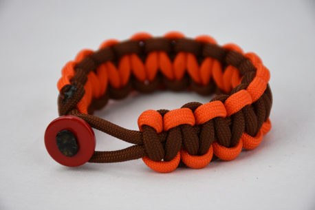 brown orange and brown paracord bracelet unity band with red button in the front, picture of a brown orange and brown paracord bracelet unity band with red button fastener in the front on a white background