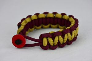 burgundy burgundy and gold paracord bracelet unity band with red button in the front, picture of a burgundy burgundy and gold paracord bracelet unity band with red button fastener in the front on a white background
