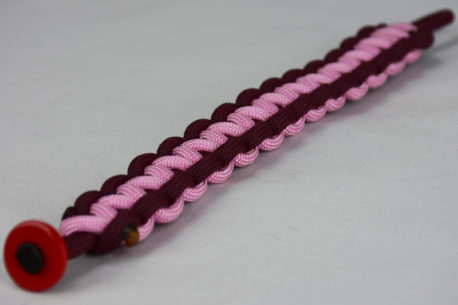 burgundy burgundy and soft pink paracord bracelet unity band with red button in the front corner on a white background, picture of a burgundy burgundy and soft pink paracord bracelet unity band with red button fastener on a white background