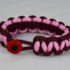 burgundy burgundy and soft pink paracord bracelet unity band with red button front, picture of a burgundy burgundy and soft pink paracord bracelet unity band with red button fastener in the front on a white background