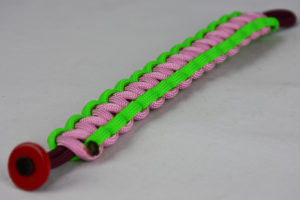 burgundy neon green and soft pink paracord bracelet unity band with red button in the front corner on a white background
