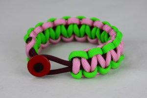 burgundy neon green and soft pink paracord bracelet unity band with red button in front, picture of a burgundy neon green and soft pink paracord bracelet unity band with red button fastener in the front on a white background