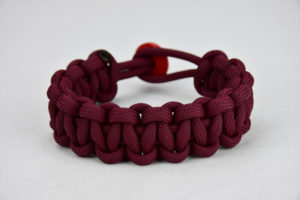 burgundy paracord bracelet unity band with red button in back, picture of a burgundy paracord bracelet with red button fastener in the back and on a white background