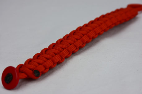 burnt orange paracord bracelet unity band with red button corner, picture of a burnt orange paracord bracelet with red button fastener on a white background