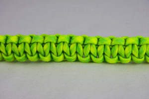 dayglow camouflage paracord bracelet across the center of a white background
