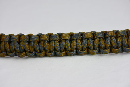 desert foliage camouflage paracord bracelet going across the middle of a white background