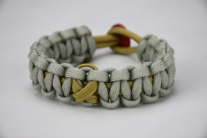 gold and grey pediatric cancer support paracord bracelet unity band, picture of a gold and grey paracord bracelet with a gold ribbon in the center and red button in the back