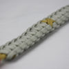 gold and grey pediatric cancer support paracord bracelet with gold ribbon and red button in the front corner