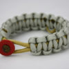gold and grey pediatric cancer support paracord bracelet unity band, picture of a gold and grey pediatric cancer support paracord bracelet with a gold ribbon in the center and a red button fastener in the front