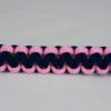 gold soft pink and navy blue paracord bracelet across the center of a white background