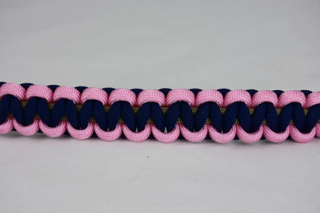 gold soft pink and navy blue paracord bracelet across the center of a white background