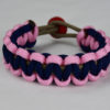 gold soft pink and navy blue paracord bracelet unity band with red button back, picture of a gold soft pink and navy blue paracord bracelet unity band with red button fastener in the back of a white background