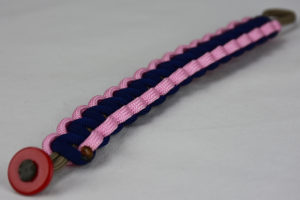 gold soft pink and navy blue paracord bracelet unity band with red button fastener in the front corner