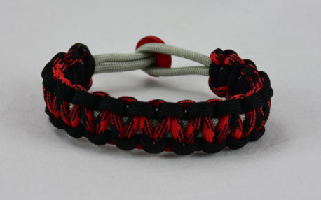grey black red and black camouflage machine gun kelly paracord bracelet with red button in back