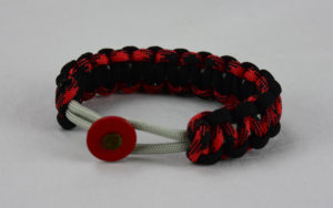 grey black red and black camouflage machine gun kelly paracord bracelet with red button fastener in the front