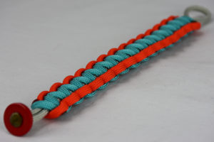 grey orange and teal paracord bracelet unity band with red button in the front corner on a white background