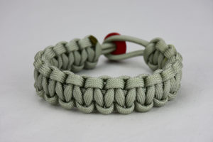 grey paracord bracelet with red button, picture of a grey paracord bracelet with red button fastener on a white background