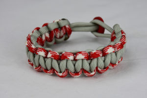 grey red and white camouflage and grey paracord bracelet unity band with red button back, picture of a grey red and white camouflage and grey paracord bracelet unity band with red button fastener on a white background