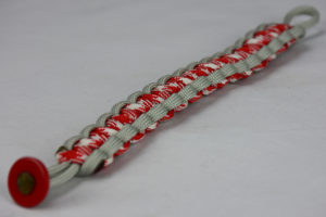 grey red and white camouflage and grey paracord bracelet unity band with red button corner on a white background