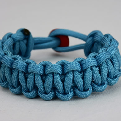 light blue paracord bracelet unity band with red button in back, picture of a light blue paracord bracelet unity band with red button fastener in the back on a white background