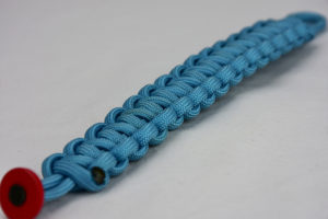 light blue paracord bracelet unity band with red button in the corner, picture of a light blue paracord bracelet unity band with red button fastener in the front corner on a white background