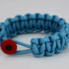 light blue paracord bracelet unity band with red button in front, picture of a light blue paracord bracelet unity band with red button fastener on a white background