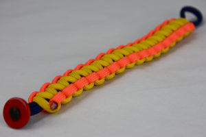 navy blue neon orange and yellow paracord bracelet unity band with red button fastener in the corner on a white background
