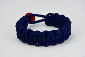 navy blue paracord bracelet unity band with red button, picture of a navy blue paracord bracelet unity band with red button fastener in the back on a white background