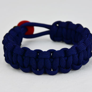 navy blue paracord bracelet unity band with red button, picture of a navy blue paracord bracelet unity band with red button fastener in the back on a white background