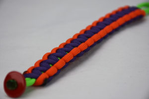 neon green orange and purple paracord bracelet unity band with red button in the bottom corner