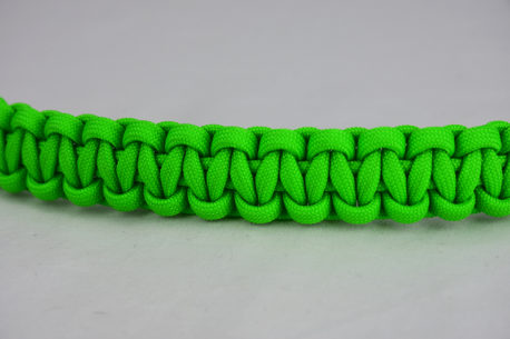 neon green paracord bracelet unity band across the center of a white background