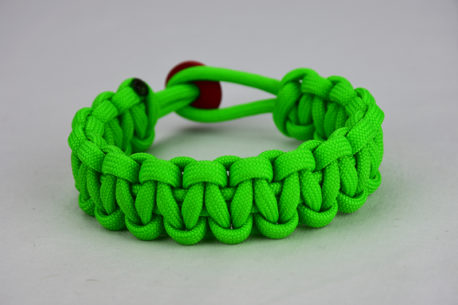 neon green paracord bracelet unity band with red button in back, picture of a neon green paracord bracelet unity band with red button fastener in the back on a white background