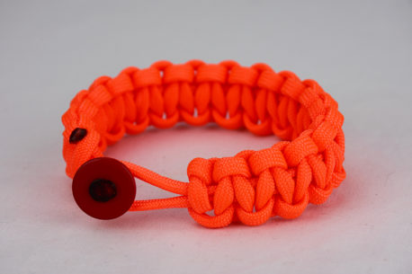 neon orange paracord bracelet unity band with red button, picture of a neon orange paracord bracelet unity band with red button in the front on a white background