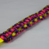 neon yellow purple and yellow camouflage pink and purple camouflage paracord bracelet unity band with red button in the front corner on a white background