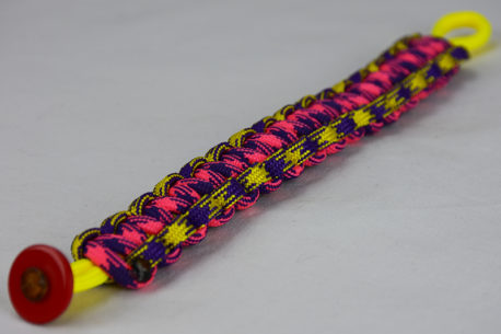 neon yellow purple and yellow camouflage pink and purple camouflage paracord bracelet unity band with red button in the front corner on a white background