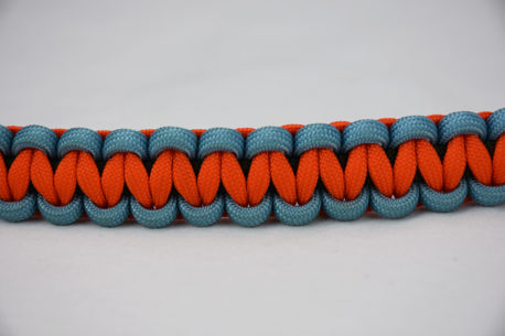 od green light blue and orange paracord bracelet going across the middle of a white background