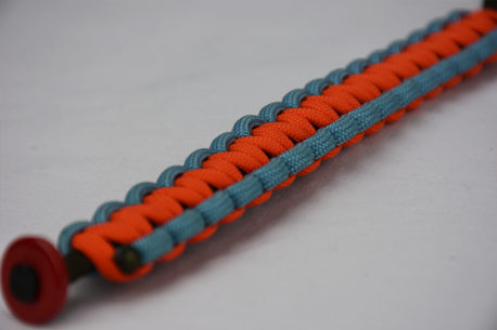 od green light blue and orange paracord bracelet with red button in the corner, picture of an od green light blue and orange paracord bracelet with red button fastener on a white background