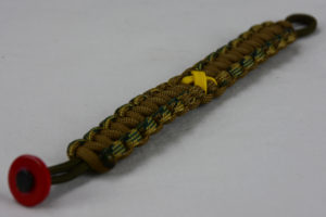 od green multicam camouflage and coyote brown military support paracord bracelet with red button fastener in the corner and yellow ribbon