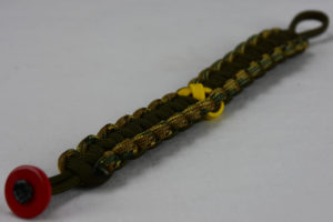 od green mulitcam camouflage and od green military support paracord bracelet with red button fastener in the corner and yellow ribbon