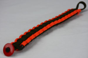 od green orange and od green paracord bracelet unity band with red button fastener in the front corner