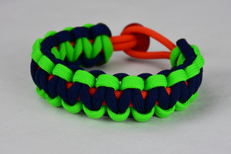 orange neon green and navy blue paracord bracelet with red button back, picture of an orange neon green and navy blue paracord bracelet with red button fastener in the back on a white background