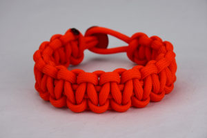 orange paracord bracelet unity band, picture of a orange paracord bracelet with a red button in the back, orange unity band paracord bracelet