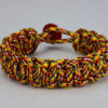 overkill camouflage paracord bracelet unity band with red button in the back, picture of an overkill camouflage paracord bracelet unity band with red button fastener in the back