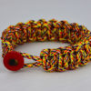overkill camouflage paracord bracelet unity band with red button in front, picture of an overkill camouflage paracord bracelet unity band with red button fastener on a white background