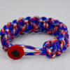 patriotic camouflage paracord bracelet with red button front, picture of a patriotic camouflage paracord bracelet unity band with red button fastener in the front, red white and blue camouflage for patriotism